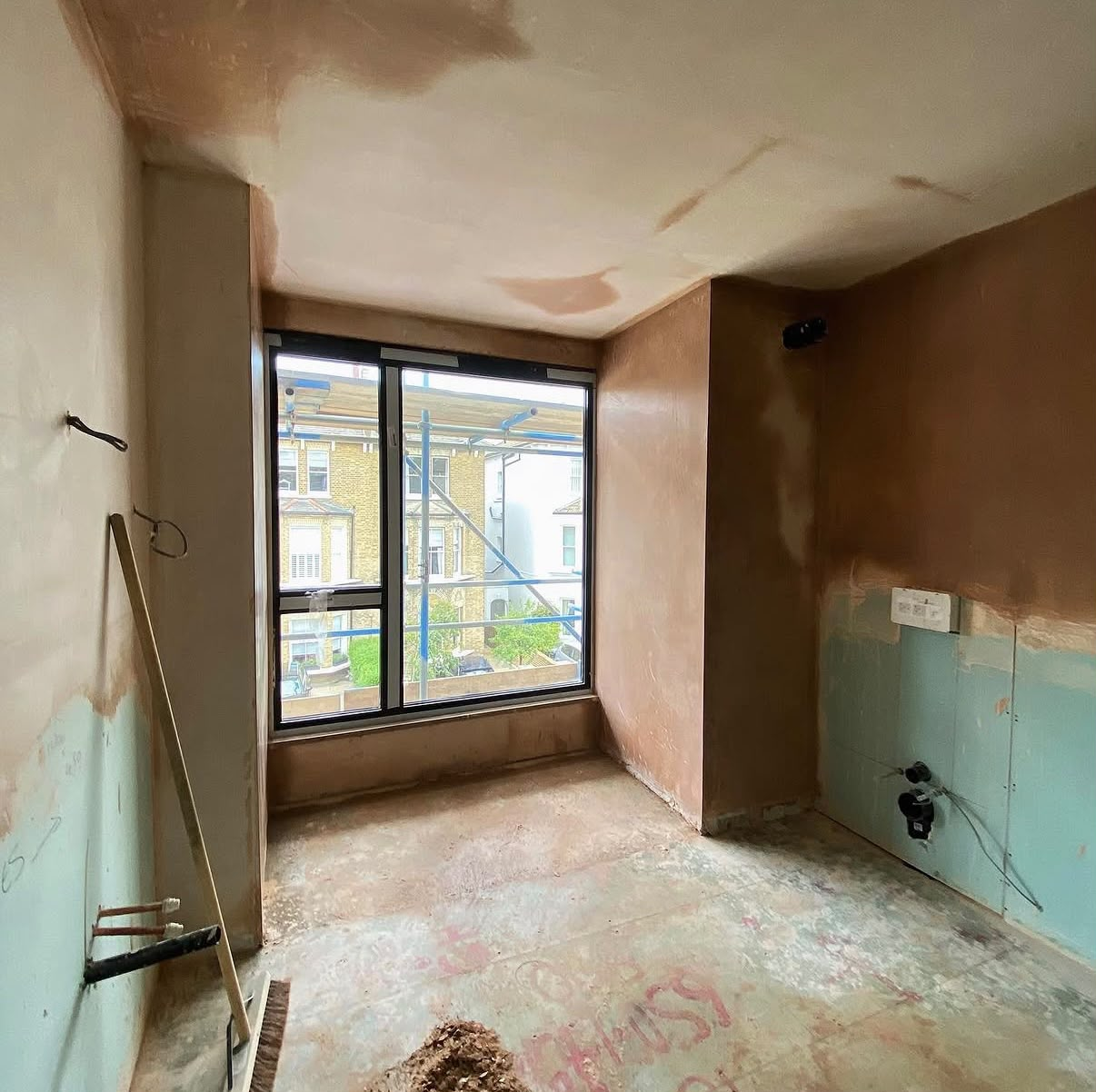 Room stripped back ready for replastering - new windows installed